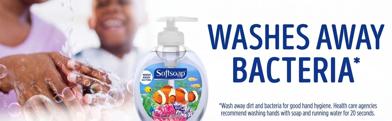 A promotional banner for Softsoap hand soap featuring the slogan 'WASHES AWAY BACTERIA*' in bold blue text on a white background. On the left, a close-up shows hands being washed with soapy bubbles alongside a child in the background. In the center is a bottle of Softsoap with a clownfish design. At the bottom right, a footnote disclaimer reads: '*Wash away dirt and bacteria for good hand hygiene. Health care agencies recommend washing hands with soap and running water for 20 seconds.