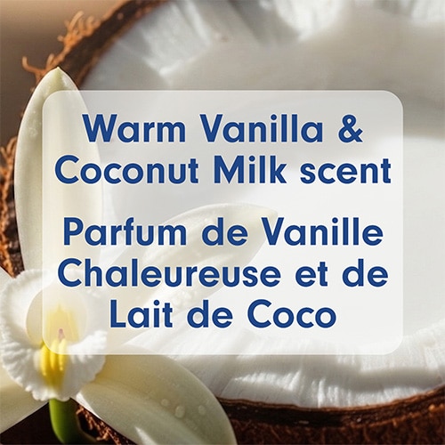 Close-up of a white vanilla orchid flower and a cracked open fresh coconut, overlayed with the text "Warm Vanilla & Coconut Milk scent".