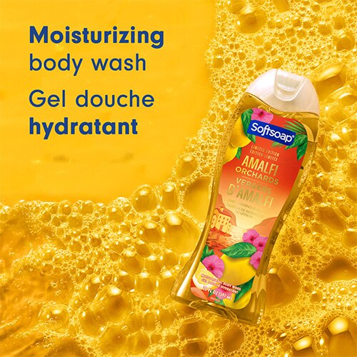 Le flacon de gel douche Amalfi Orchards, posé sur un lit de bulles d'eau jaune doré. Le texte sur la gauche indique « Moisturizing body wash » et « Gel douche hydratant ».