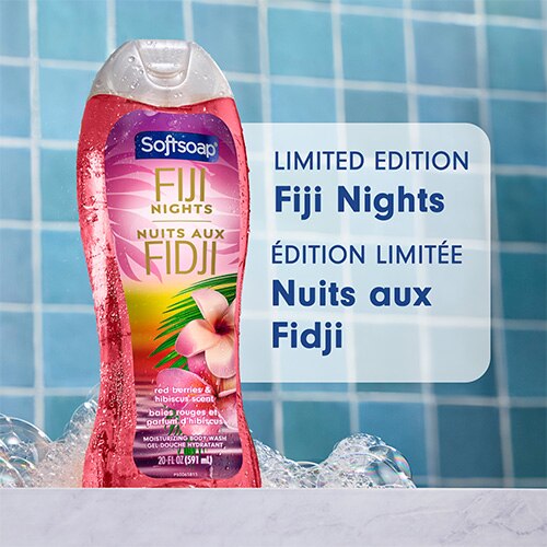 Une bouteille de 20 onces du gel douche hydratant Softsoap Fiji Nights, présentée sur un fond de carrelage bleu parsemé de bulles de savon. Un grand texte sur la droite indique « Limited Edition Fiji Nights », accompagné de sa traduction française : « Édition Limitée Nuits aux Fidji ».