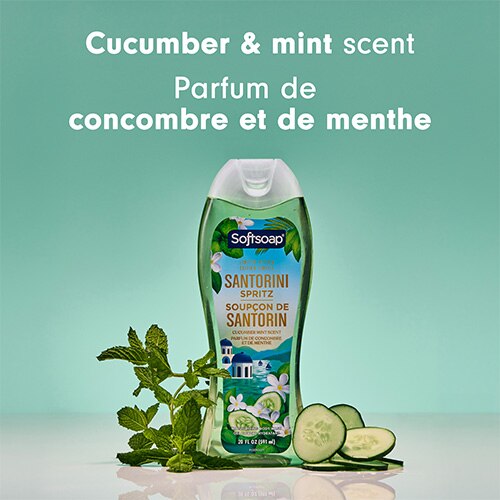 Une bouteille de gel douche hydratant Softsoap Santorini Spritz (édition limitée), centrée entre des feuilles de menthe fraîche et des tranches de concombre. Le texte au-dessus indique « Cucumber & mint scent » et « Parfum de concombre et de menthe ».